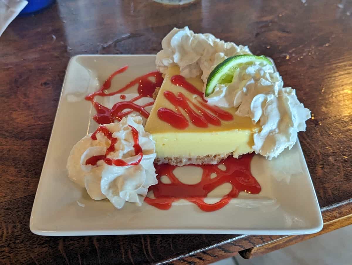 a slice of Key lime pie with cream from Alonzo's Oyster Bar dessert menu