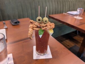 Crabby Bloody Mary topped with a fried soft-shell crab and olives at Square Grouper in Key West