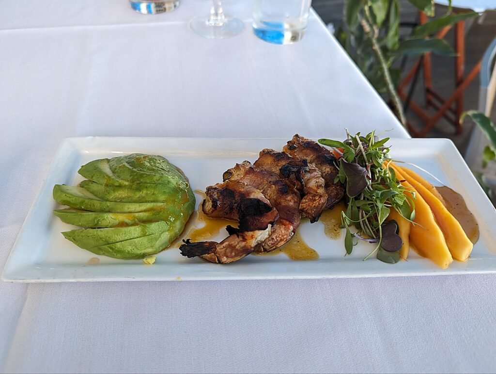 Grilled bacon wrapped shrimp with papaya, avocado and passionfruit mustard at Louie's Backyard