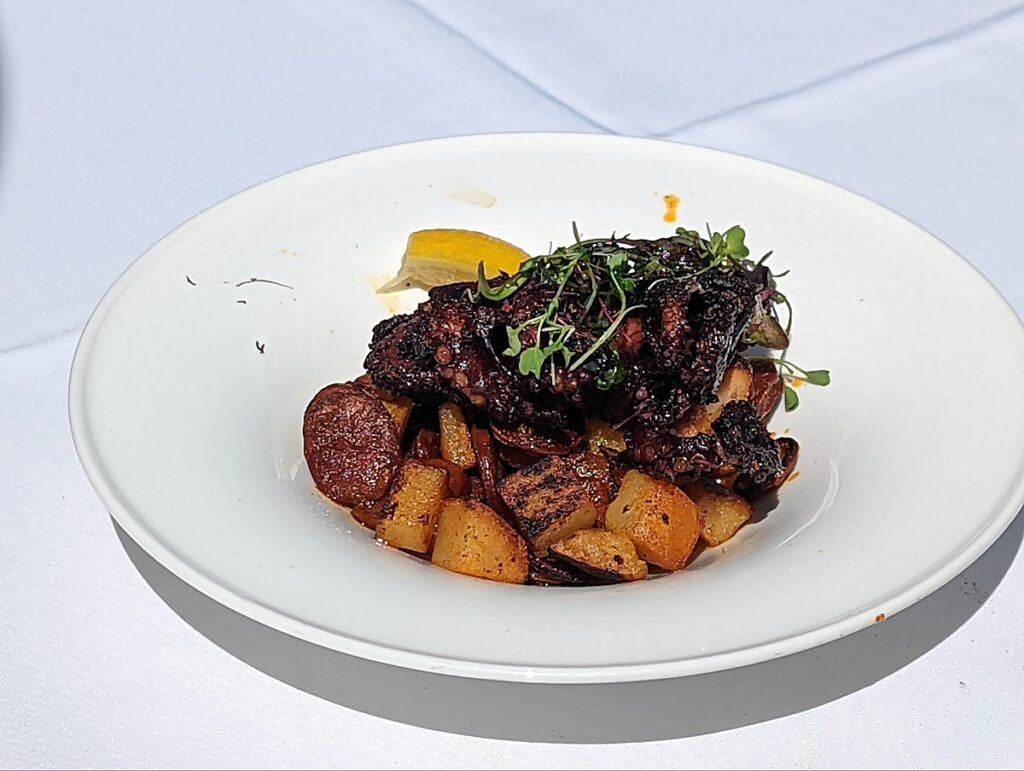 Charred baby octopus with chorizo, potatoes and chili oil at Louie's Backyard in Key West